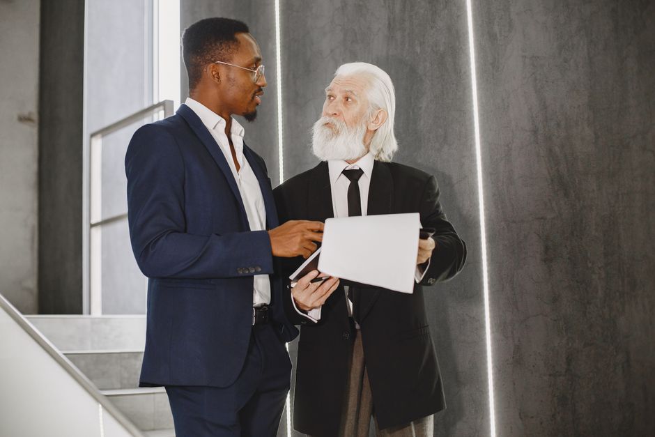 Senior mentor guiding a younger professional