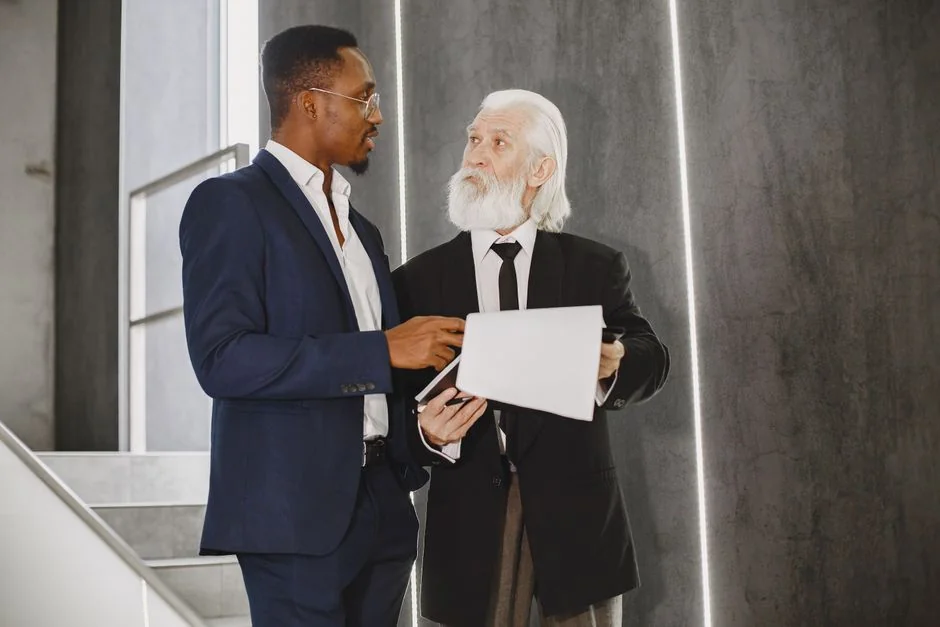 Senior mentor guiding a younger professional