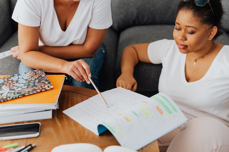 Tutor working through a notebook with a student
